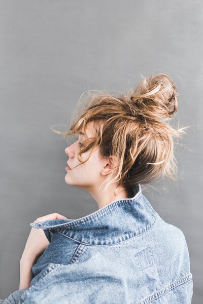 back-view-of-woman-holding-her-denim-jacket-789812