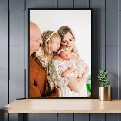framed photo of family kissing newborn captured by Springfield MO newborn photographer The XO Photography
