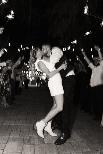 black and white sparkler exit kiss at Bowing Oaks Wedding in Jacksonville, Florida