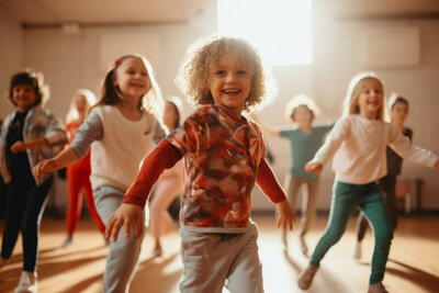 Young boy dancing in sunlight filled classroom