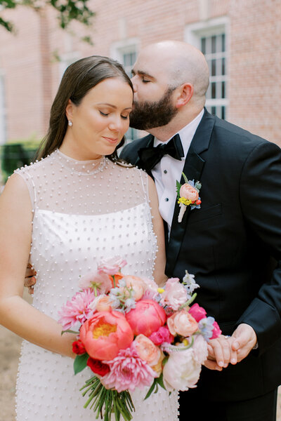 Bride and groom with pink bouquet