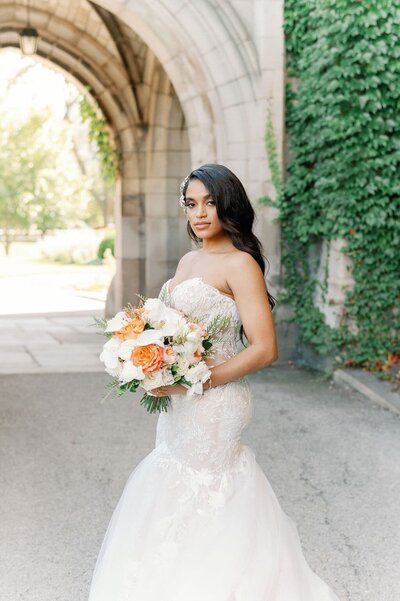 Chicago bride holding orange and white bouquet