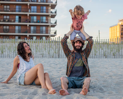 family playing games on the beach