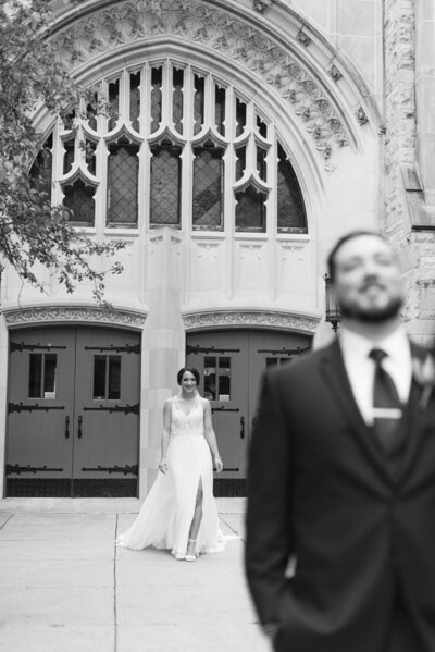 Bride walks up behind Groom for their first look. Photo by Anna Brace who specializes in Des Moines IA Wedding Photography.