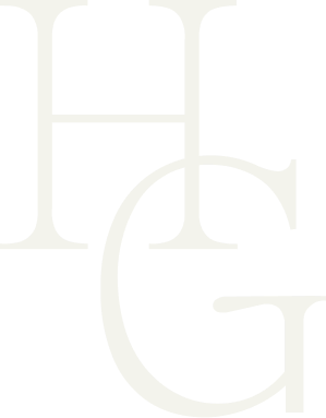 An olive green version of the Hannah Grace Photo logo. The Logo feautres a delicate handdrawn illustration of 2 buttes and the sun encased in an arch