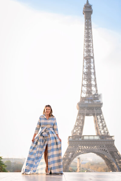 Marie standing in a dress near the Eiffel Tower