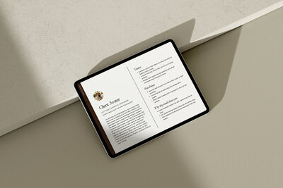 Tablet laid flat on a stone-hued surface displaying a multi-page brand audit report mockup—illustrating Gatherie Creative’s beauty, wellness, and service provider brand identity services.