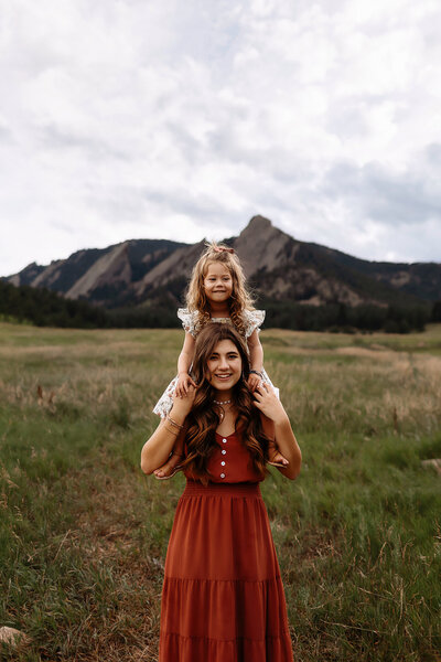 sisters playing in boulder during their sunset photos