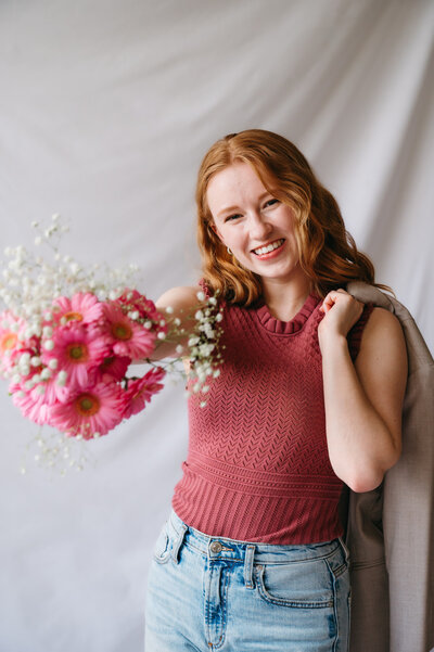 Emma, a brand and website designer, holding flowers