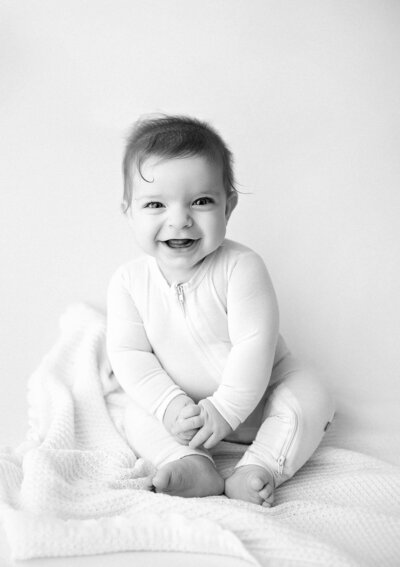A woman since against bright backlight with babiesbreath posed for a Photographer in Vancouver