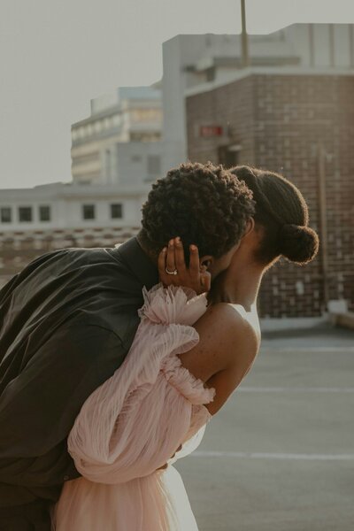 Black man and woman leaning back and embracing one another