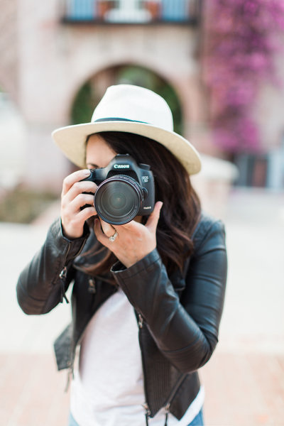 Portrait of Katie Jane Photography in Denver holding a camera