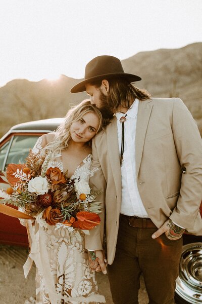 groom kissing brides forehead