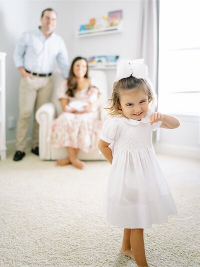 Dad gazes at daughter in lgiht and airy family session at home- 