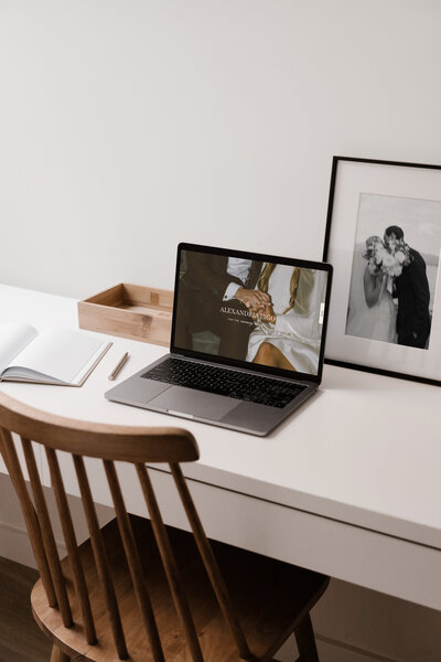 Website mockup in MacBook sitting on a white desk