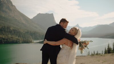 Bride and groom with arms around each other while laughing