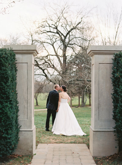Bride and groom at historic estate entrance – Luxury Wedding Photography Seattle