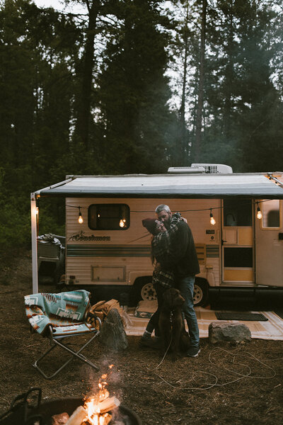 couple in front of camper
