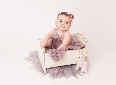 Best NYC Baby photographer captures baby girl  6 months old photos lilac setup