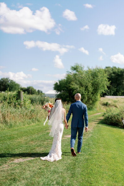 minneapolis wedding photography of groom looking at bride holding bouquet, by Natalie Bauer
