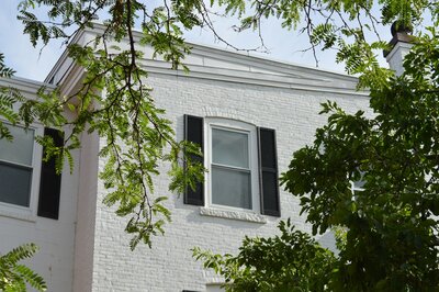 white brick house with black shutters