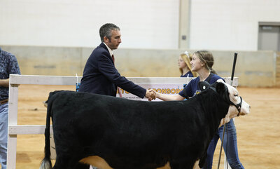 Shaking hands after being named show winner