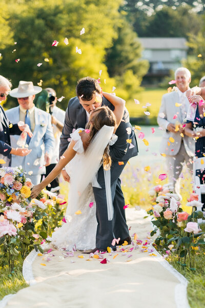 Maryland Wedding Photography, Couple kisses during petal toss, Kimberly Dean Photos 