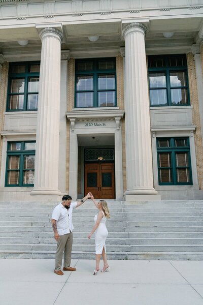 Bride and groom dancing in front of courthouse, taken by east coast wedding photographer Shelby Ann Photos