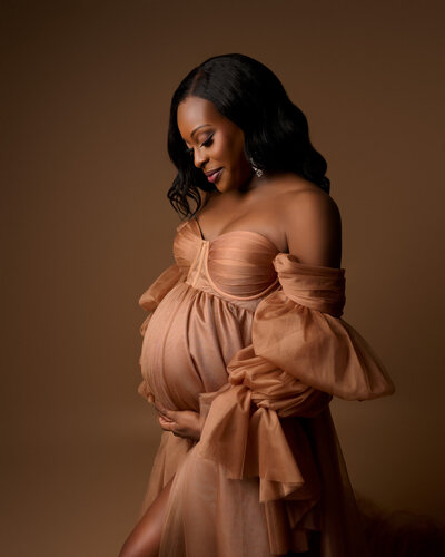 Pregnant woman peach gown maternity portrait Austin professional photographer