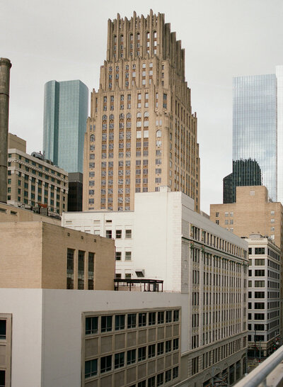 Architectural view of downtown Houston skyline with art deco detailing, ideal for editorial wedding portraits and urban elopements.

