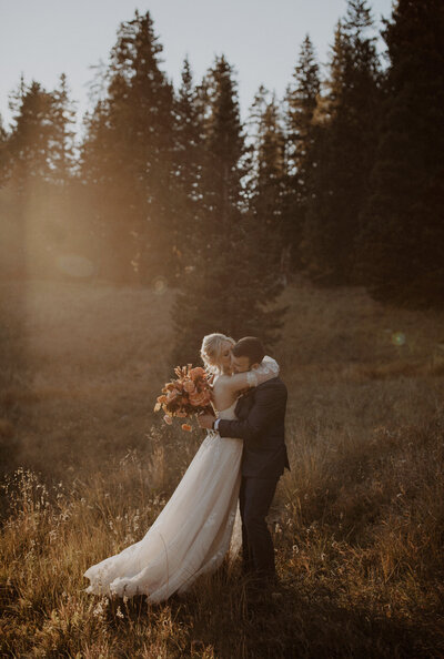 Bride and groom kiss in the Telluride mountains