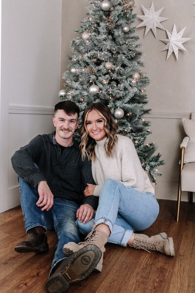 Styled Christmas photo setup at Evermore Place in Gray, Maine featuring a flocked tree and cozy seating.