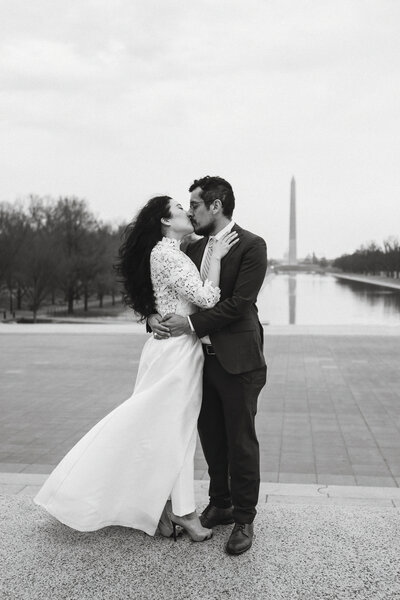 black and white photo of bride and groom kissing in front of the Washington Monument on the National Mall during their Washington DC Elopement