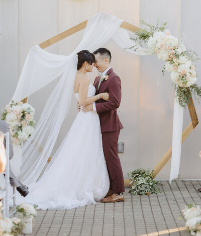Couple smiling at each other after getting married at Chabot Science Center in Oakland. Captured by San Francisco Wedding Photographer