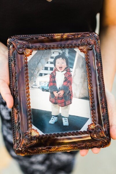 framed print of small child laughing