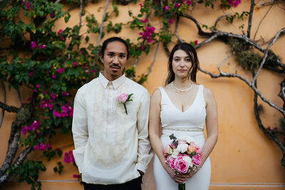 Groom and Bride posing like American Gothic painting at their Destination Elopement