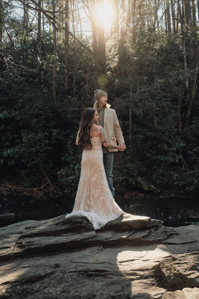 Eloping couple holding hands in the Georgia forest