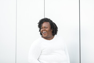 african american woman laughing at camera
