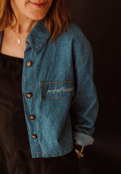 Close up of the embroidered logo for Perfect Thirds & Co on its founder's shirt.