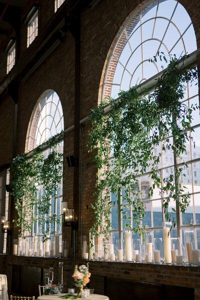 arched windows with greenery and candles