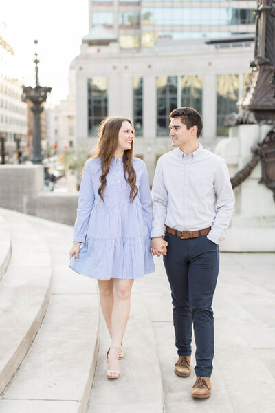 engaged couple walking through downtown indianapolis