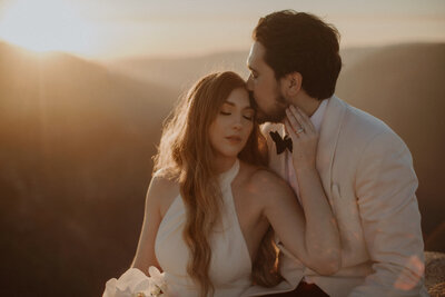 Bride and groom snuggle together at Taft Point