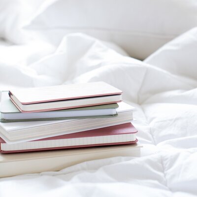 Stack of books on bed