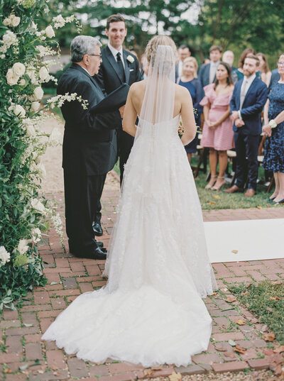 Bride walking down brick aisle at classic Washington DC wedding venue, photographed by an Editorial Wedding Photographer.