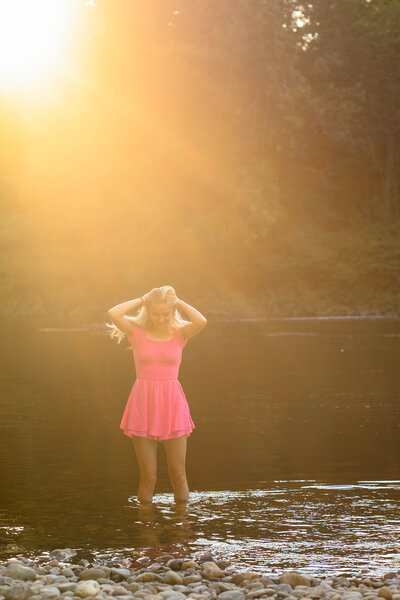 Girl in pink dress standing in water | Senior Session