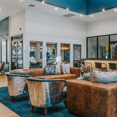 Modern lounge at The Apex at Sky Valley featuring leather seating, abstract artwork, and stylish decor.