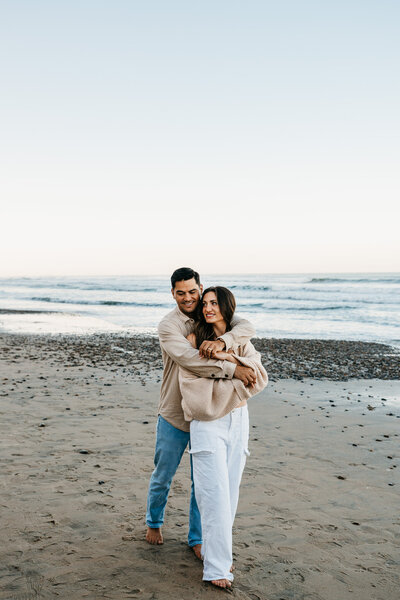 Couple hugging on beach Wedding Photography Minneapolis.