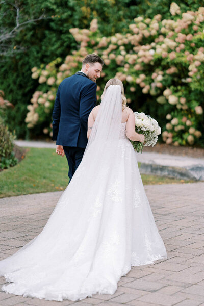 Bride and groom walking hand-in-hand after saying “I do” – romantic Ontario wedding photography at Deer Creek