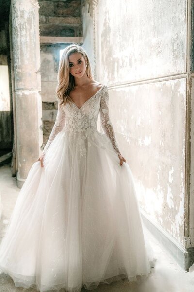 Because of the transparent illusion netting, the long sleeves and bodice of this ballgown contrast beautifully with the skin.