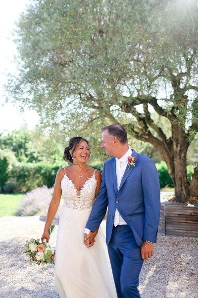 bride-and-groom-holding-hands-at-luxury-destination-wedding-in-le-castellet-provence-by-leslie-choucard-photography